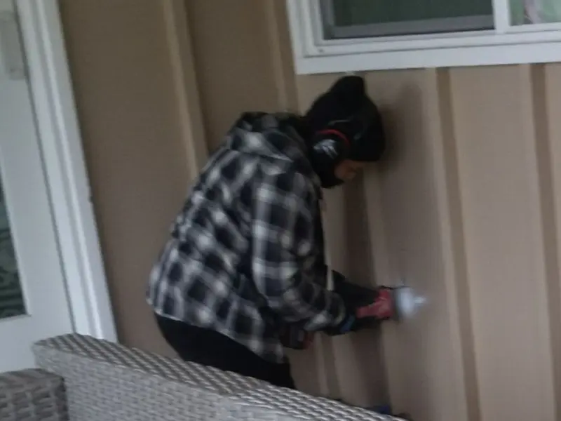 Professional electrician installing an exterior outlet in Seminole